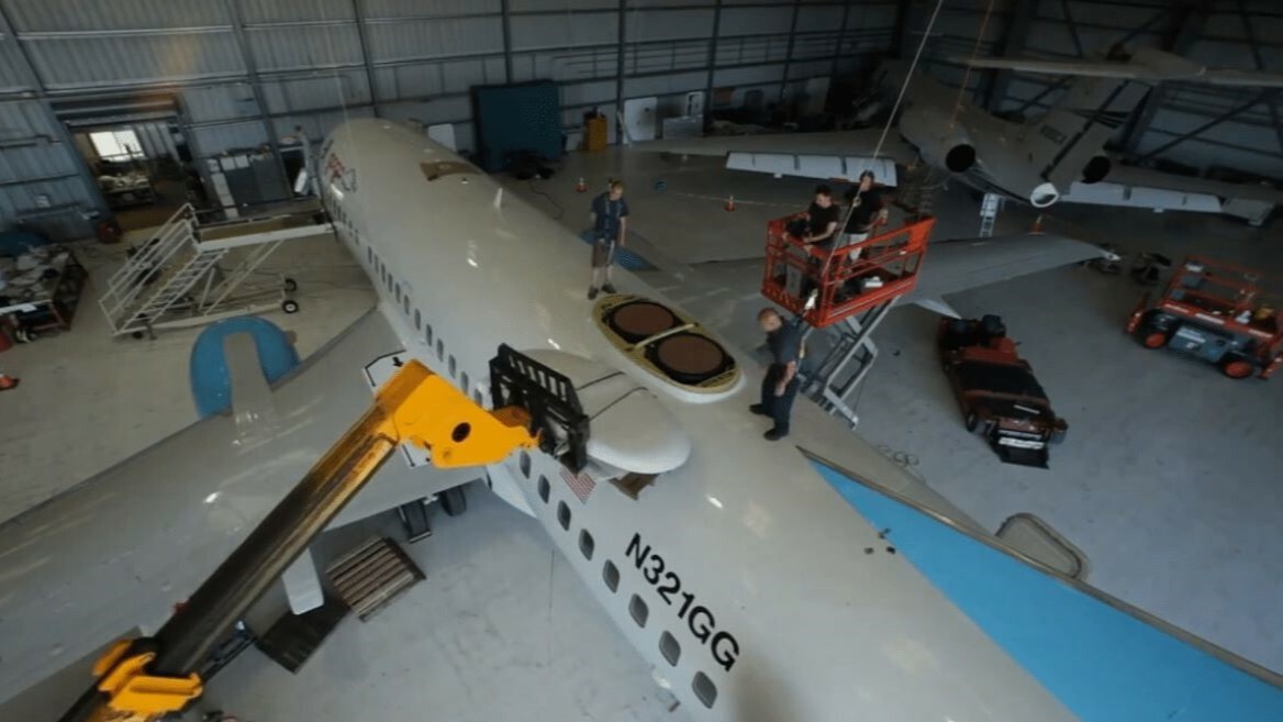 A team of workers working on an airplane