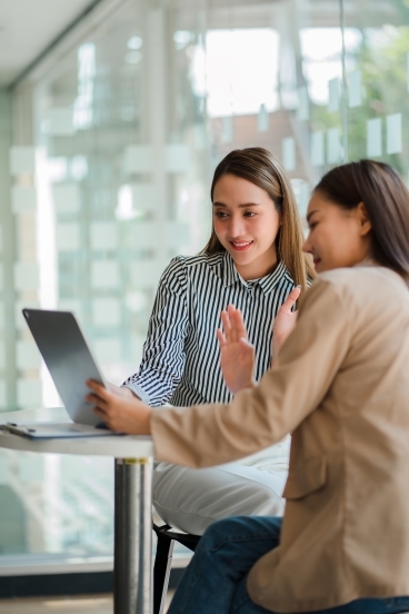 Two women looking at a laptop screen