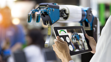 engineer controlling a robotic hand with an touch pad
