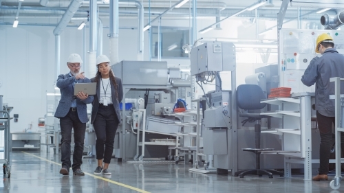 Two Industry Engineers walking through a factory for supplier assessment