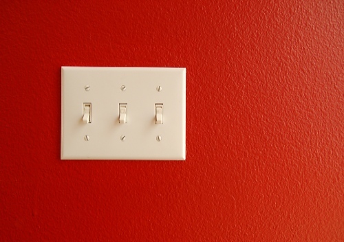 mechanical switch for light controls on a red wall